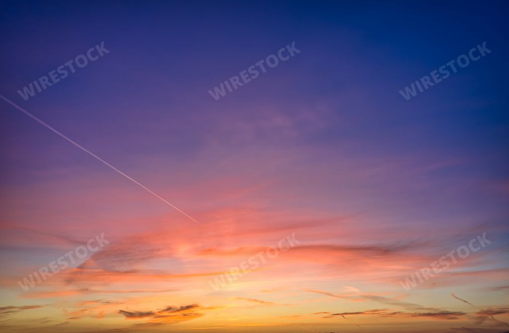 A beautiful sunset sky over Venice, California with many colors and a contrail