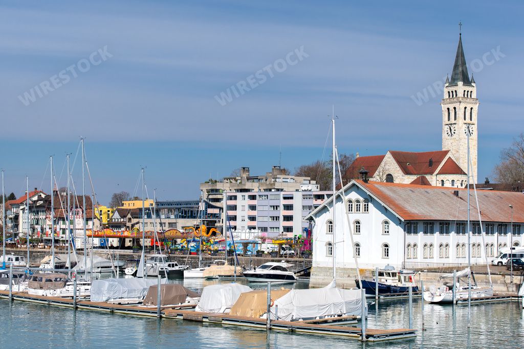 An idyllic scene of multiple sailboats in Bodensee Lake harbor in Switzerland