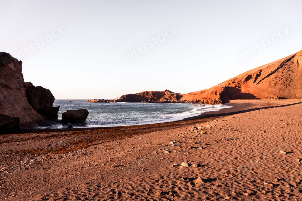 The sea waves splashing over the shore on a sunny day perfect for wallpapers and backgrounds