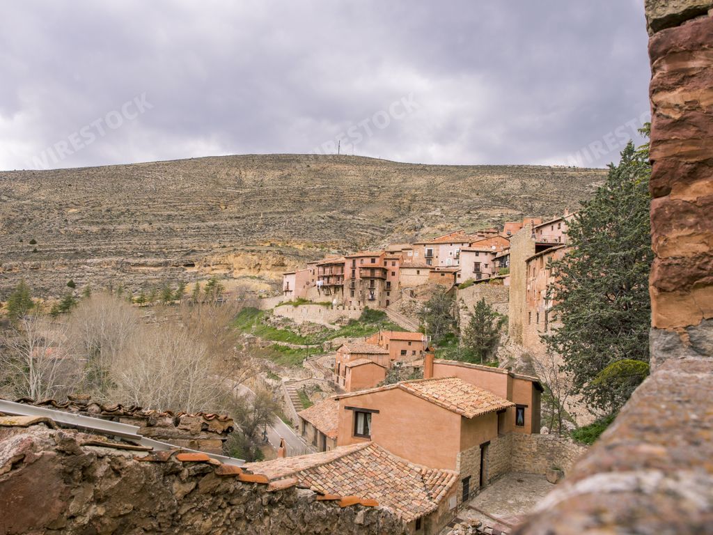 The Plaza Mayor Albarracin surrounded by hills under a cloudy sky at daytime in Teruel, Spain