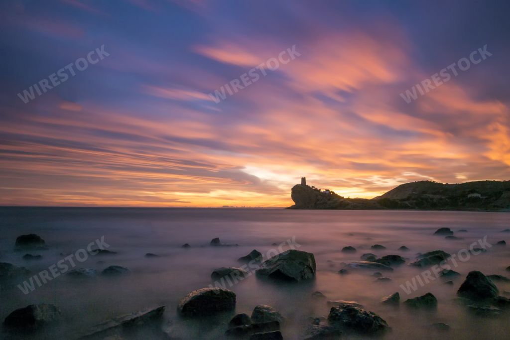A long exposure shot of the beach during a sunset