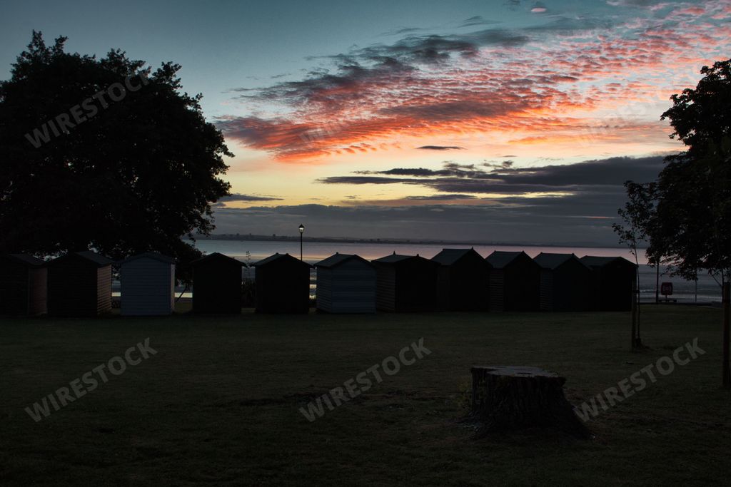 A scenic view of a landscape with a beautiful sunset in the background