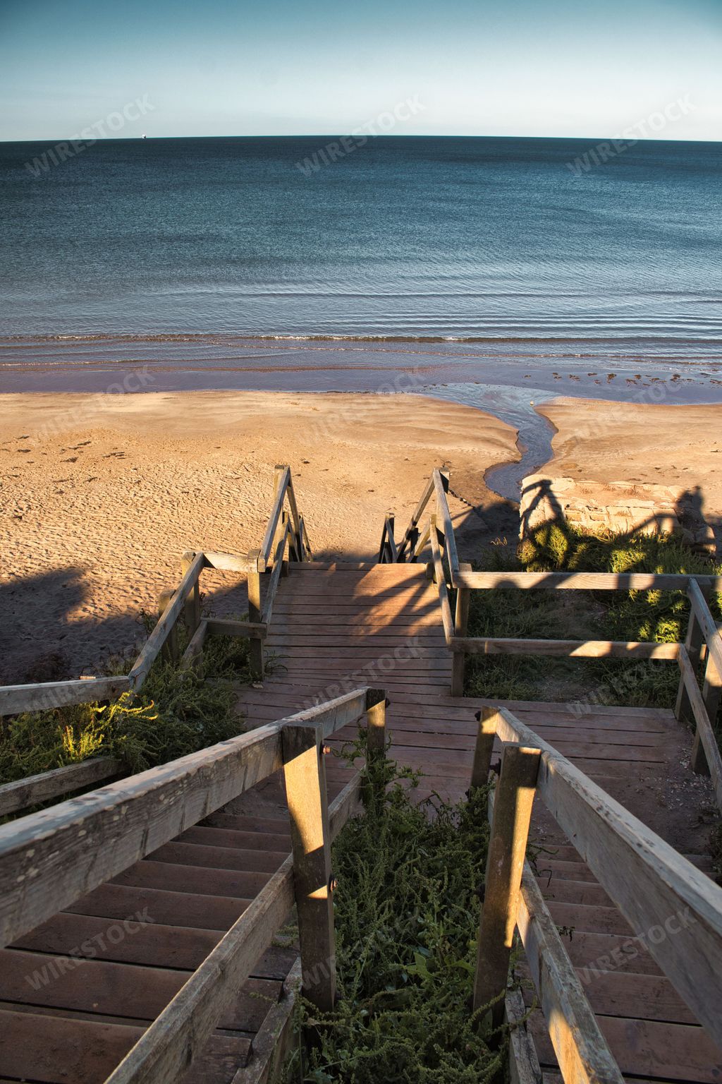 Wooden stairs leading to the beautiful Compton Bay with calm waves