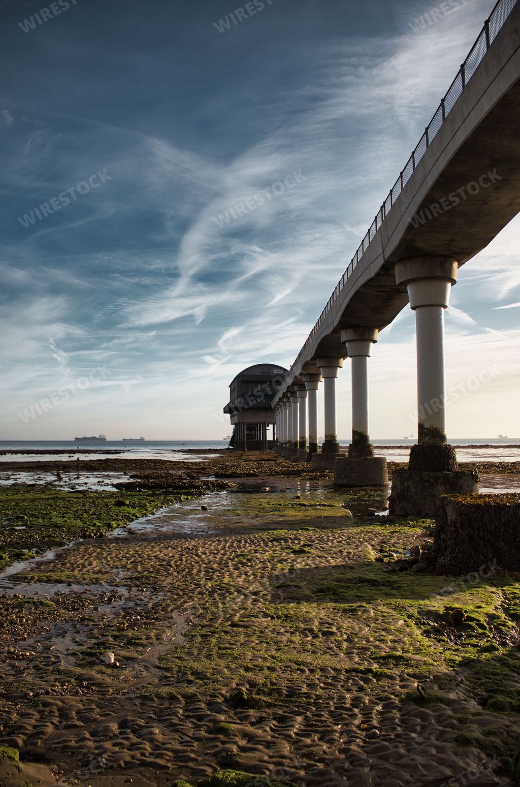 A vertical shot of columns of the Bembridge Lifeboat Station gangway on the Isle of Wight at sunset