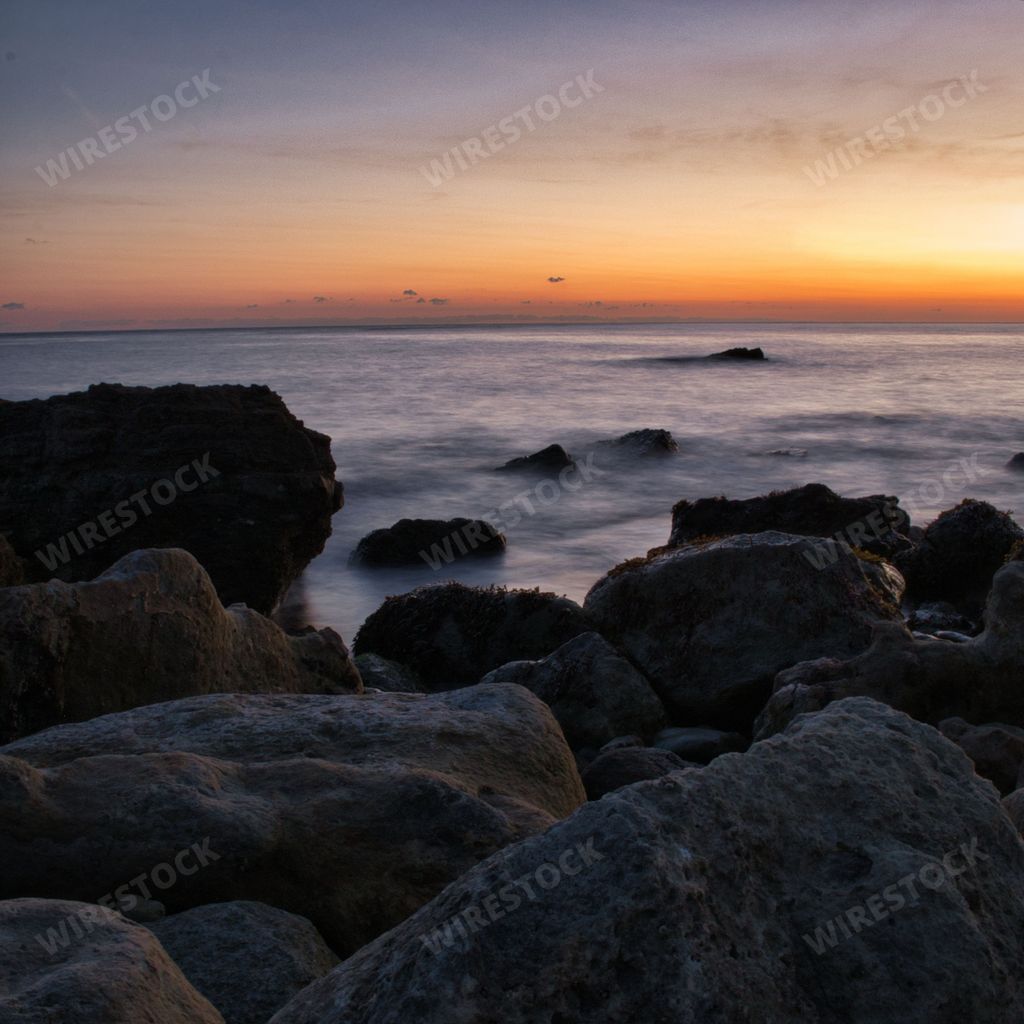 A scenic fiery sunset over the sea on the Watershoot bay of the Isle of Wight