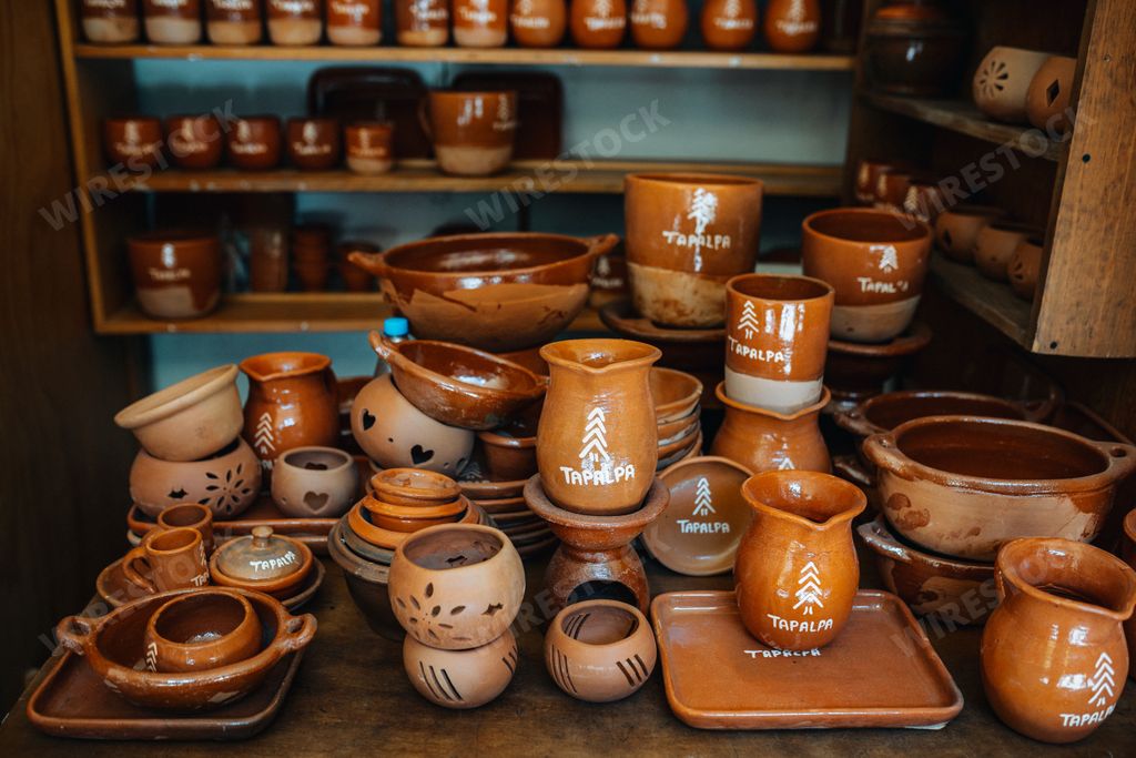 A collection of traditional Mexican pottery on display in a rustic shop in Tapalpa, Jalisco, Mexico