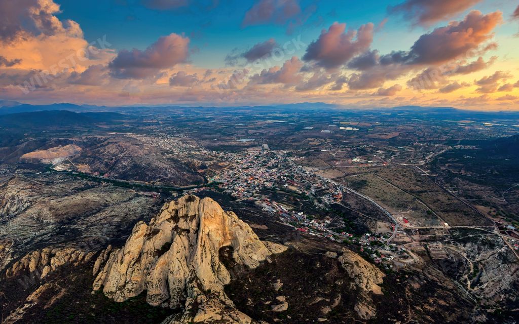 An aerial view of La Pena de Bernal monolith in Queretaro, Mexico at sunset or sunrise