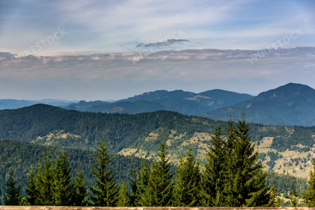 A bench on hill's edge with mountain views in Ceahlau mountain, Piatra Neamt, Romania