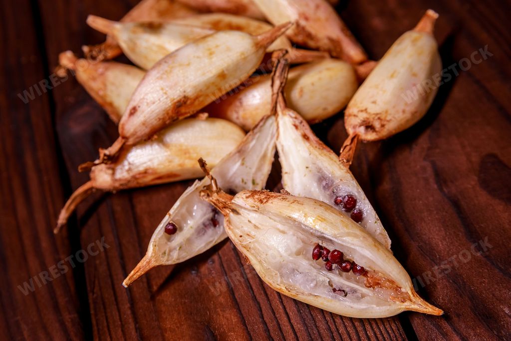 A close up shot of pinuela fruits on a dark wooden table