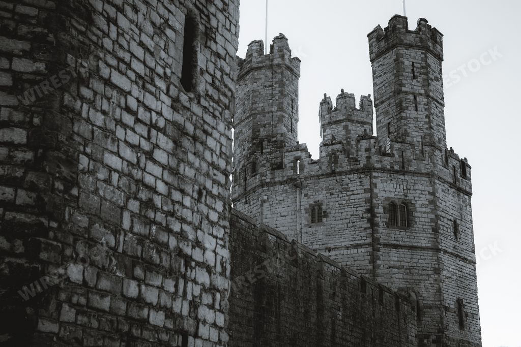 A grayscale shot of the Caernarfon Castle (Welsh: Castell Caernarfon) in Gwynedd, Wales