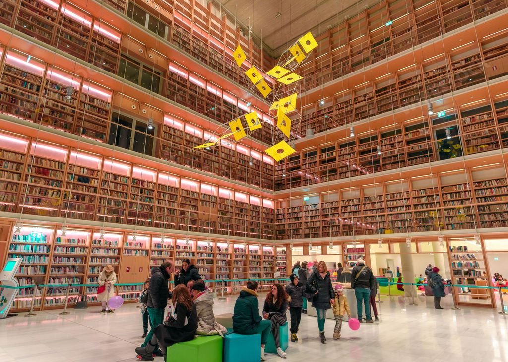 A big library and people inside the Stavros Niarchos Foundation Cultural Center in Athens