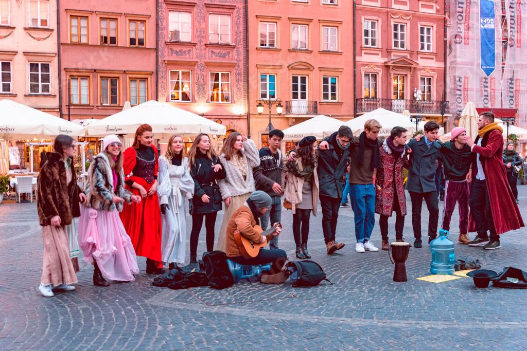 A group of dancers dancing traditional dances in a square at Warsaw Old Town, Poland