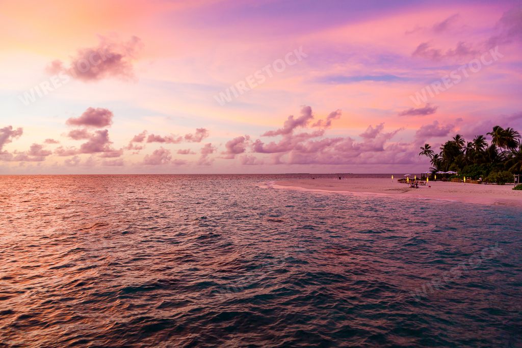 A gorgeous purple sunset view over the small island in the Maldives