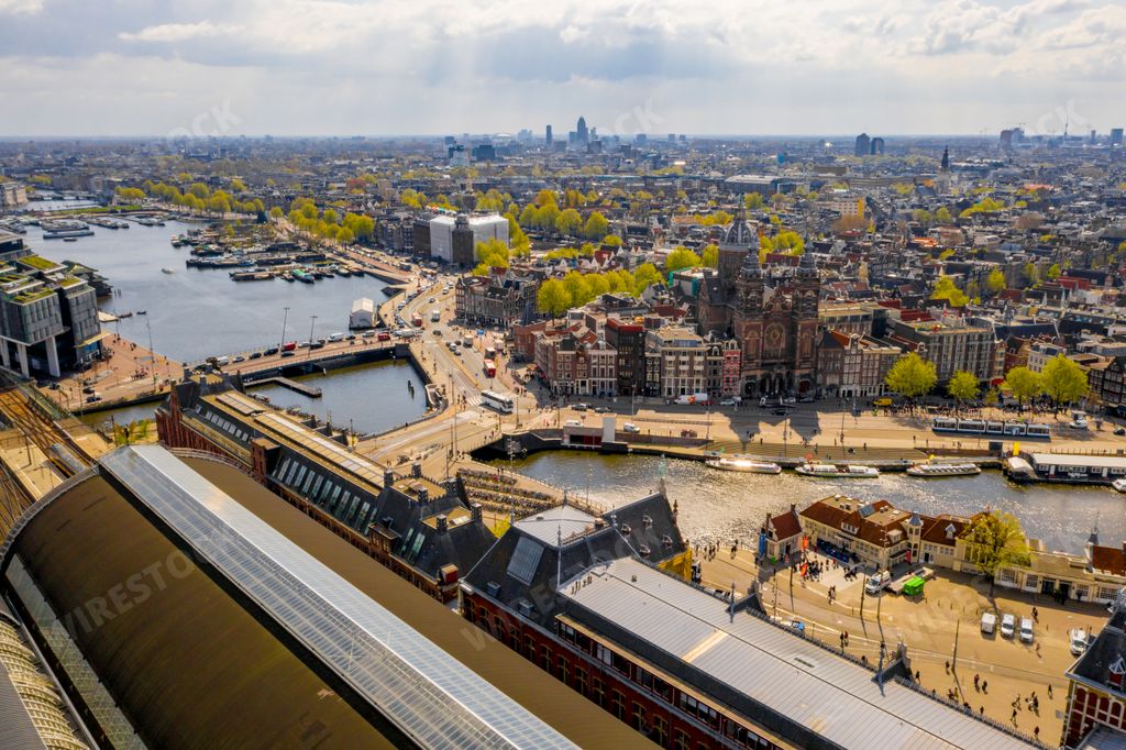 An aerial view of Amsterdam city with many narrow canals, streets and architectures