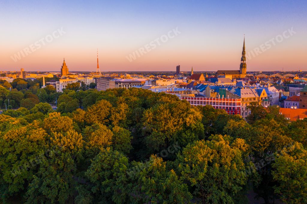 A beautiful aerial panorama of Riga center and Vansu bridge over Daugava river during sunset - view of illuminated Riga city, capital of Latvia