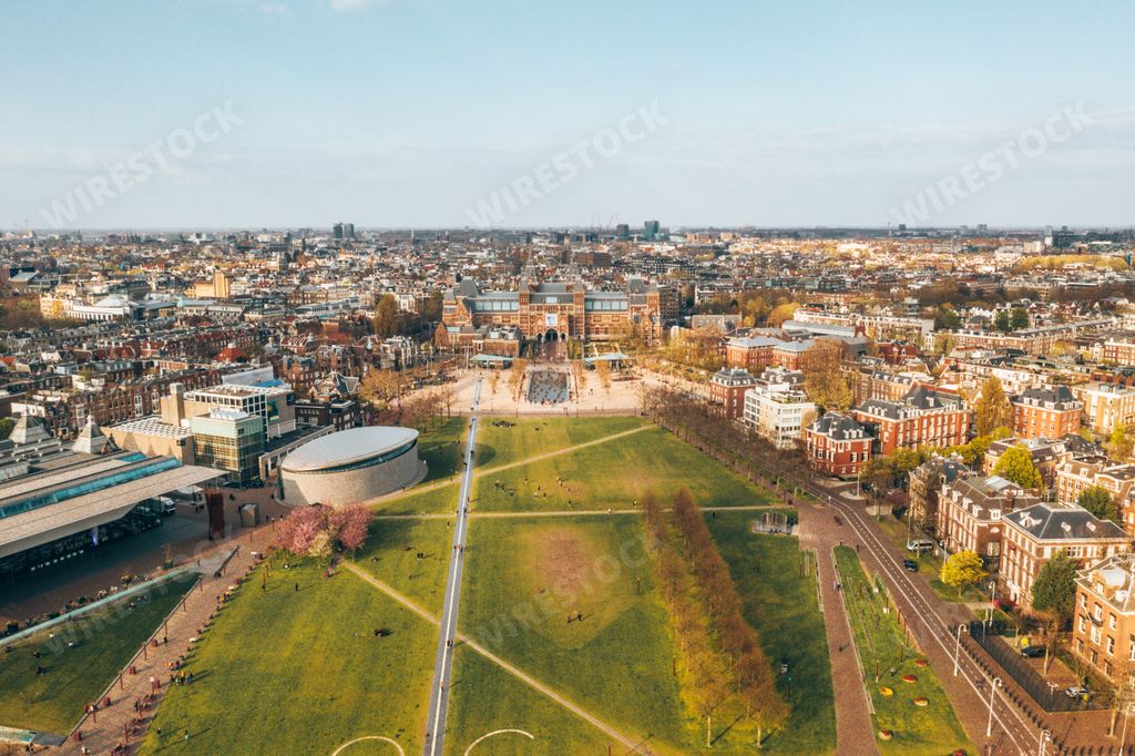 A beautiful aerial view of Amsterdam, the Netherlands with a green field in the center