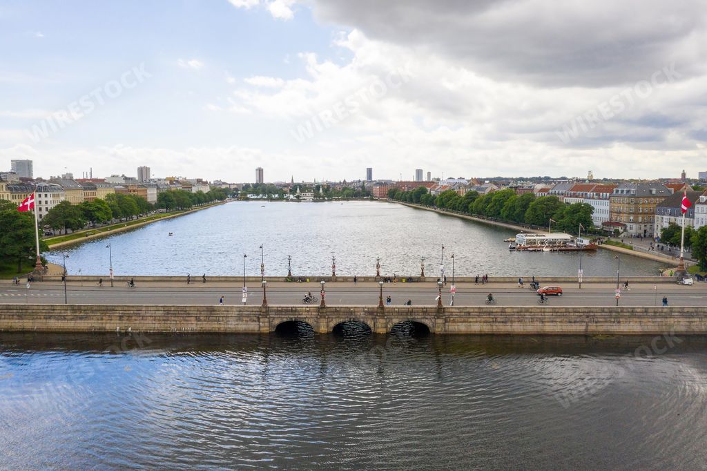 An aerial view of a concrete bridge over a river in Copenhagen, Denmark