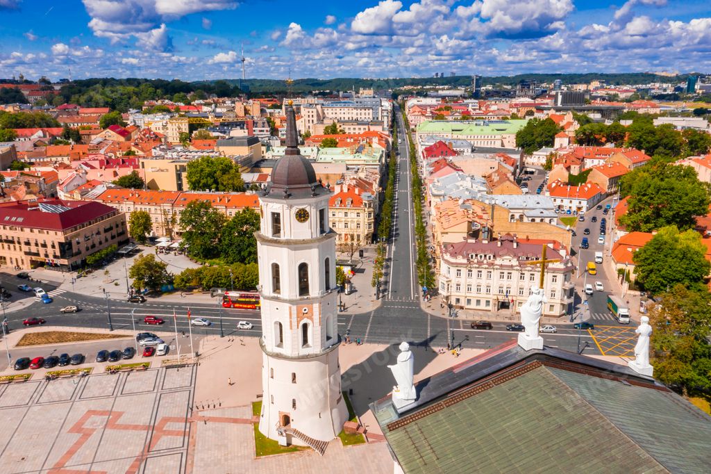 A drone view of the Cathedral Square of Vilnius under a blue cloudy sky and sunlight in Lithuania