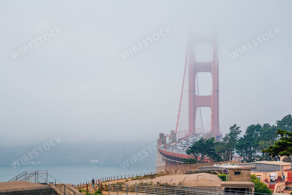 The Golden Gate bridge covered in the fog under a cloudy sky in San Francisco, California
