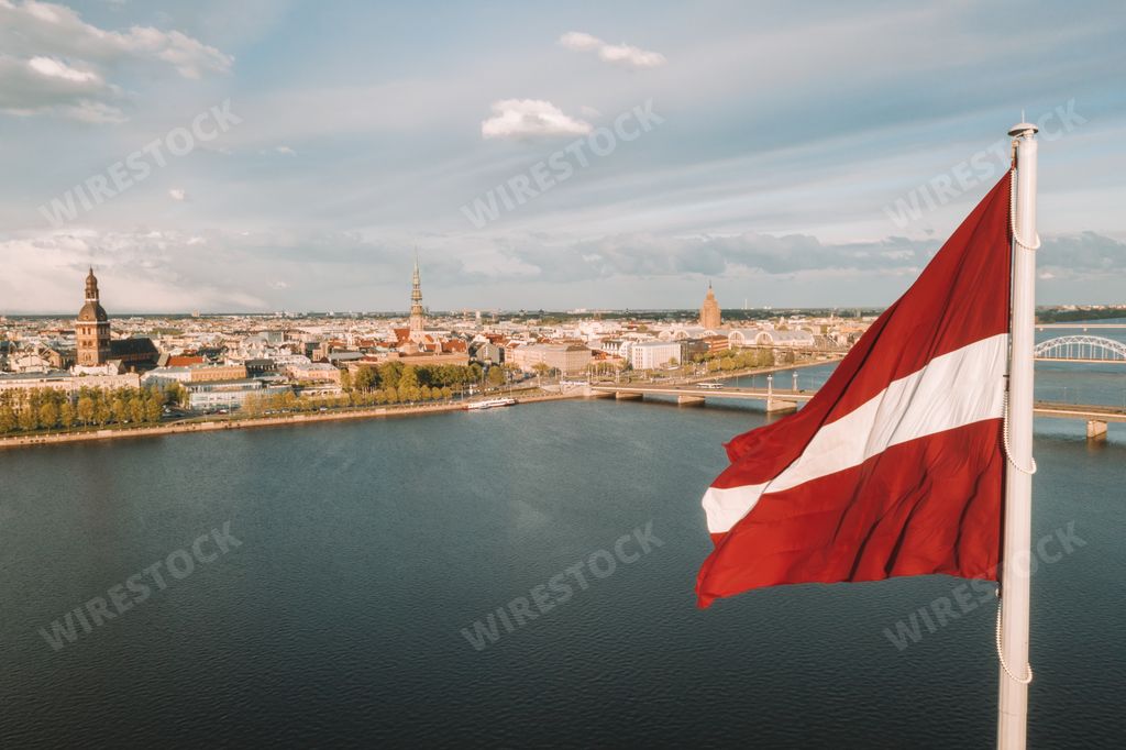 The Latvian flag waving in the sky in the beautiful city of Riga, Latvia