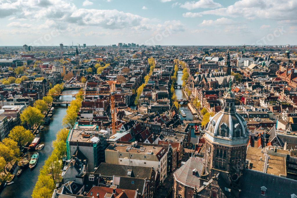 A beautiful aerial view of Amsterdam, the Netherlands with narrow streets and anals