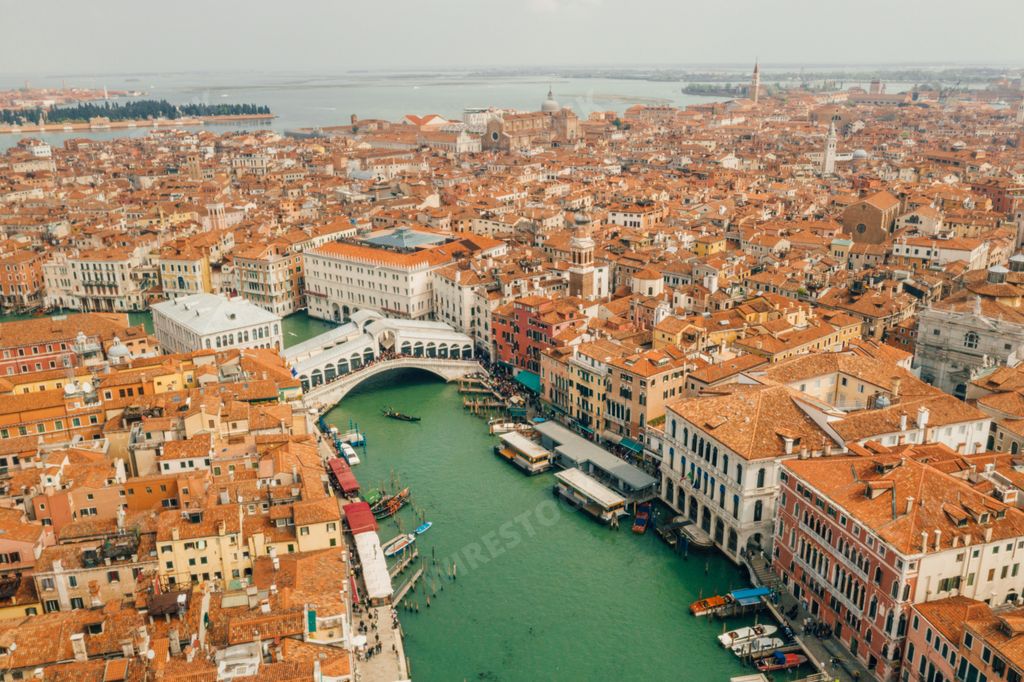 An aerial shot of the Rialto Bridge in Venice, Italy, a beautiful cityscape