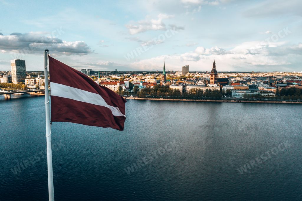 The Latvian flag waving in the sky in the beautiful city of Riga, Latvia