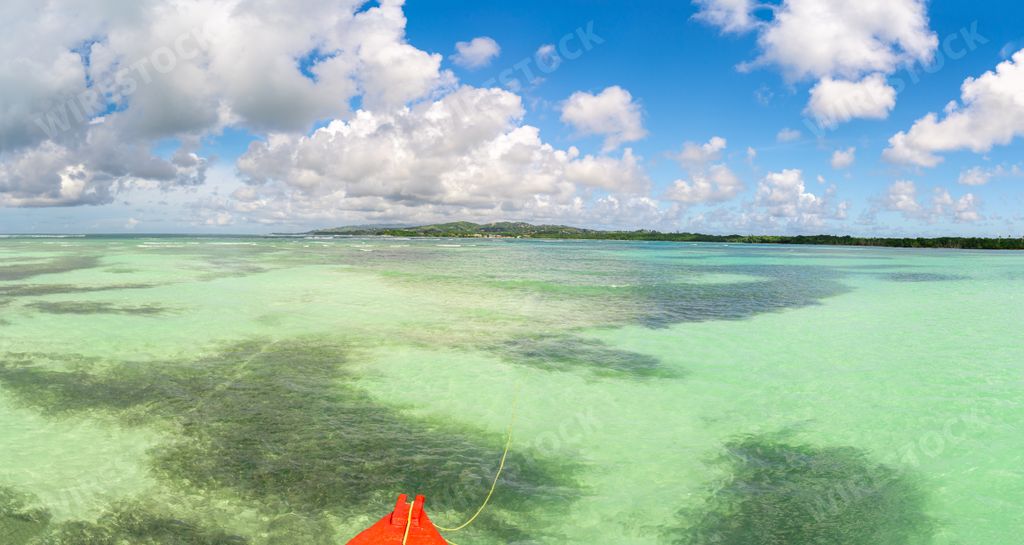 The kayak on the ocean gleaming under the cloudy sky