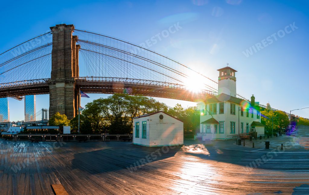 Brooklyn Bridge in the early morning viewed from Brooklyn Bridge Park with a Manhattan view in the background.