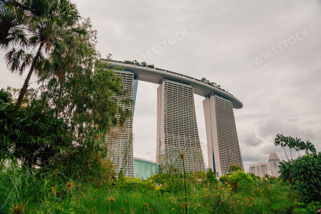The buildings in Gardens by the Bay surrounded by greenery under a cloudy sky in Singapore