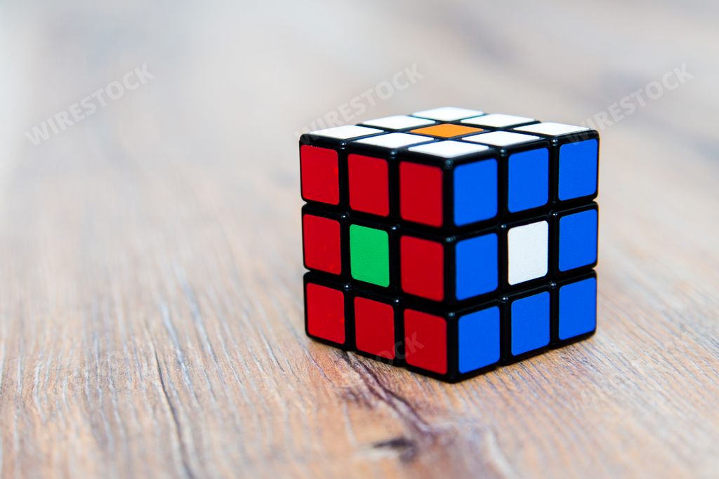 A closeup of a colorful cube toy on a wooden surface