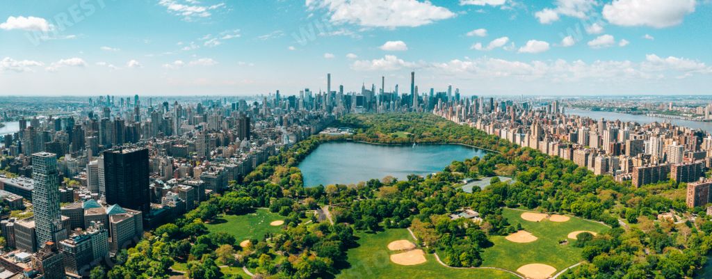 A panoramic aerial view of the Central Park in Manhattan, New York City surrounded by skyscrapers