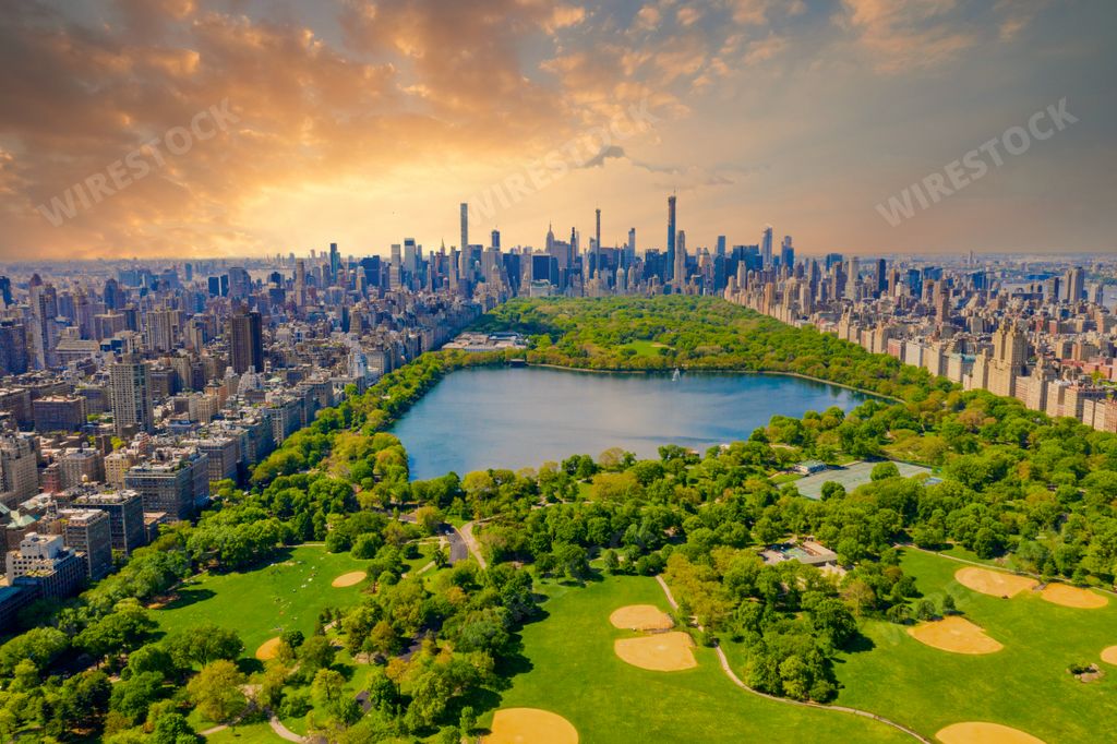 An aerial view of the Central park in New York with golf fields and tall skyscrapers surrounding the park