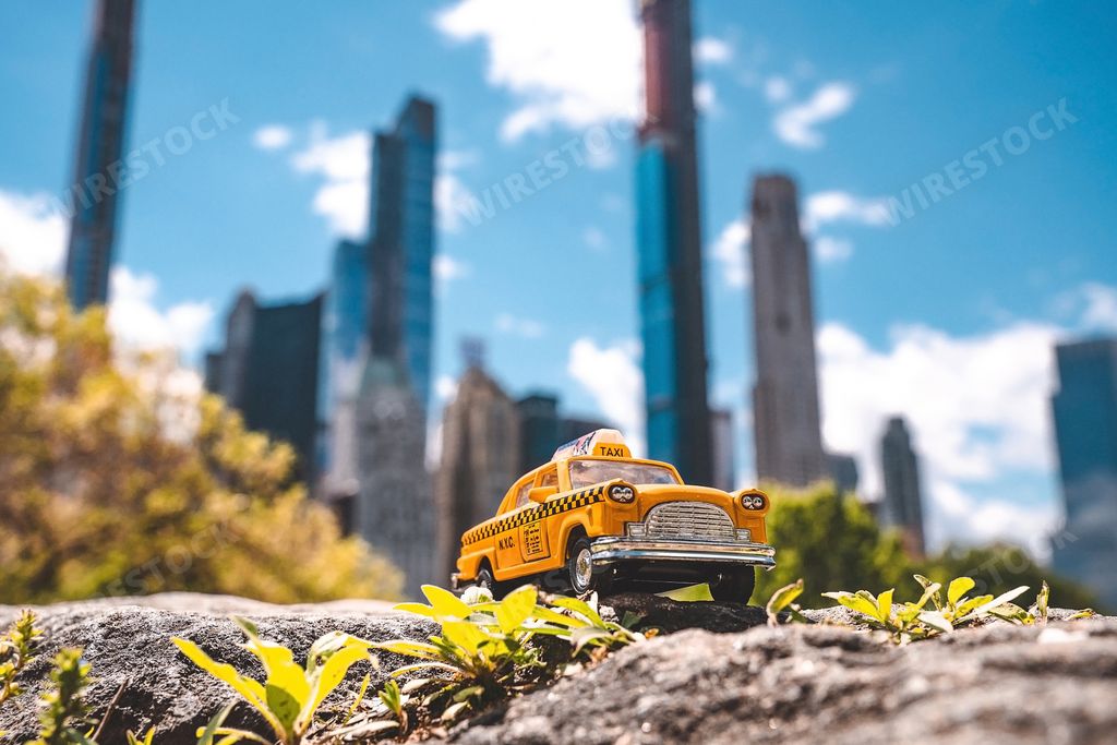 A closeup shot of a classic yellow taxi toy cab on a blurred background