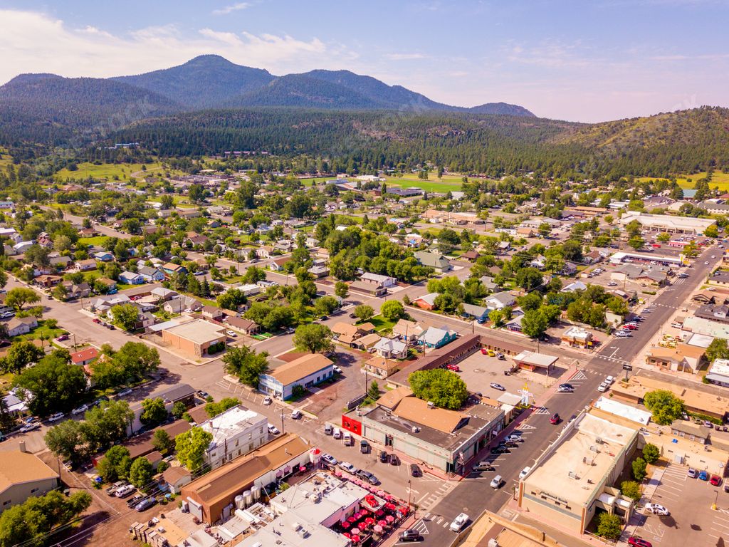 An aerial view of the city center in Williams, Arizona with a mountain landscape background