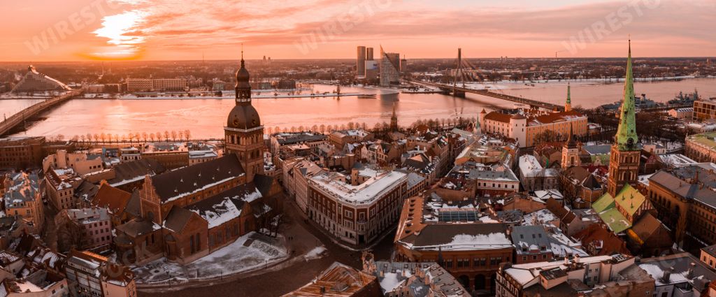 An aerial shot of the beautiful city of Riga and the Danube River in Latvia under a sunset sky