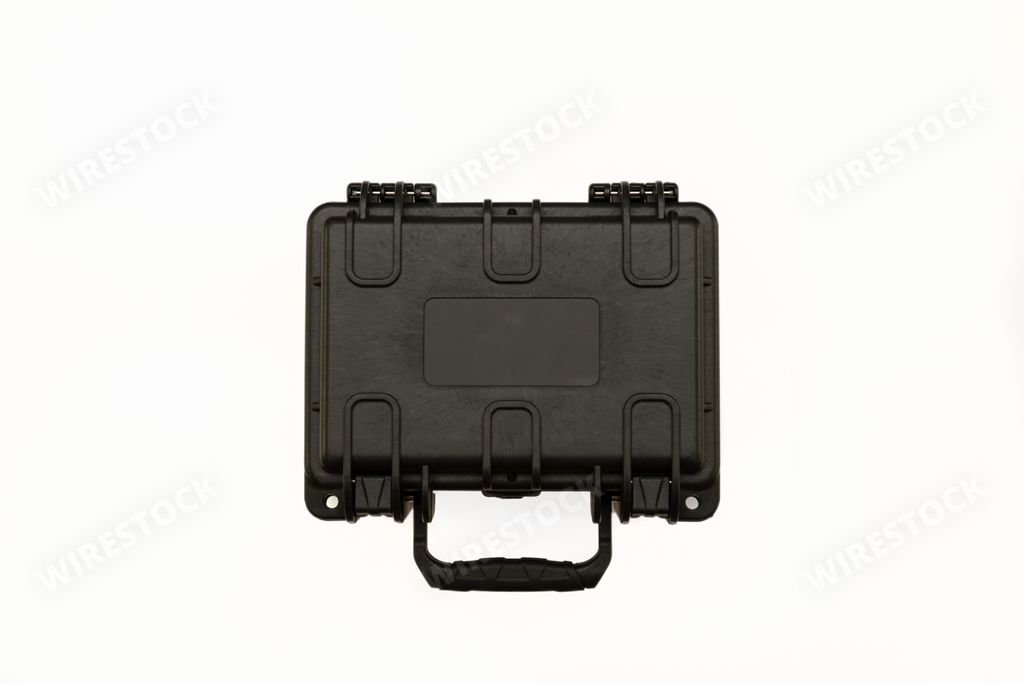 An isolated black plastic case with foam inside. Black plastic hard case for transporting and storing weapons on a white background.