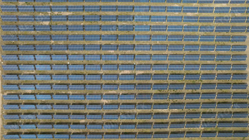 An aerial view of solar panels on a farm - the concept of renewable energy