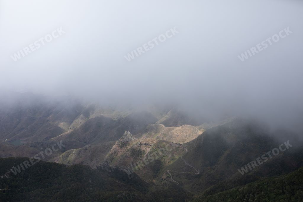 The beautiful view of mountains covered with fog