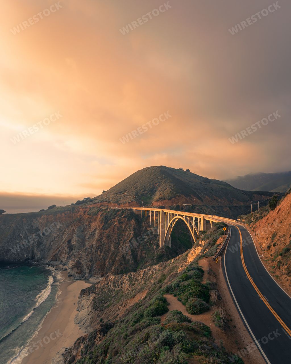 Vertical scenic view of the Pacific coast highway and Bixby Creek Bridge in California, USA at sunrise