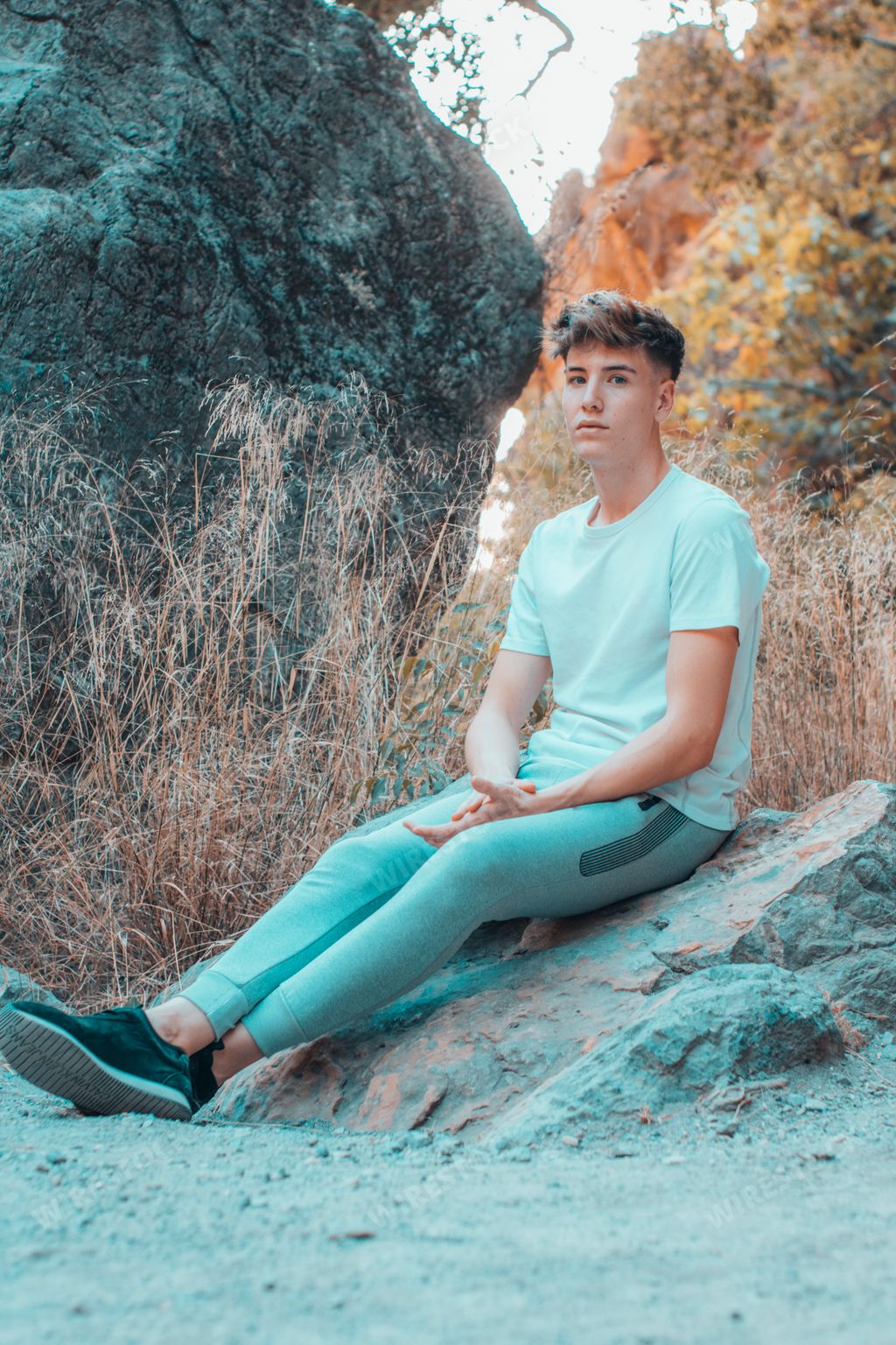 A blonde Spanish young hiker man relaxing on the mountain
