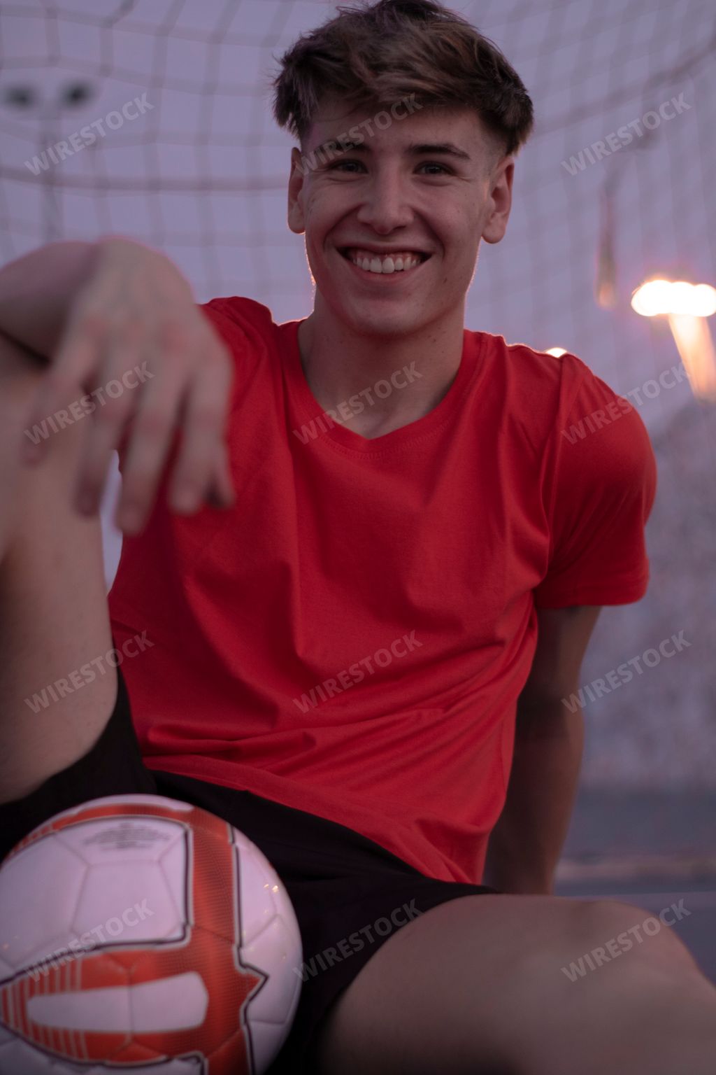 A blonde Spanish football player near the gates