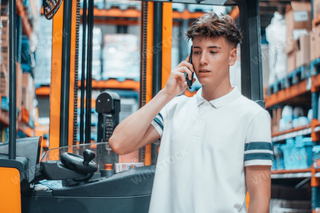 A Caucasian guy with white shirt speaking on phone