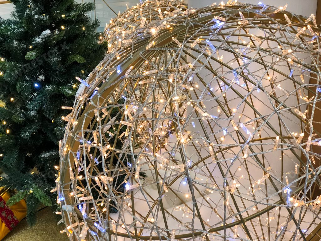A closeup shot of the Chrismas decoration with lights on the Christmas tree background