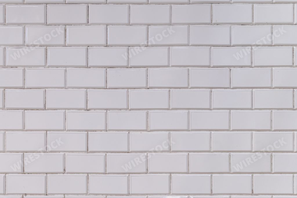 A white textured old porcelain wall tile on the station of Budapest metro line