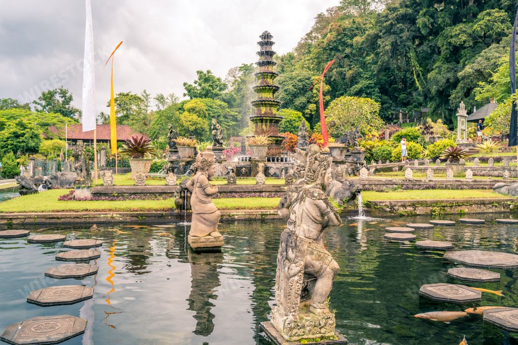 A beautiful Water Palace of Tirta Gangga with fountains and traditional Hindu demons statues, Karangasem, Indonesia