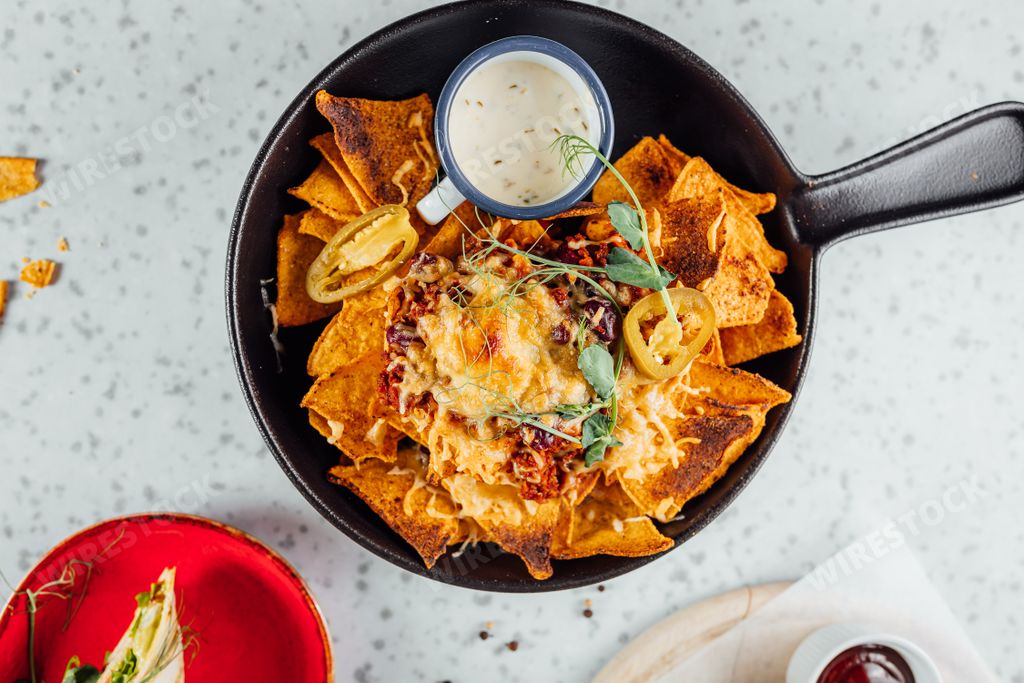 Potato chips with cheese, jalapenos and white sauce
