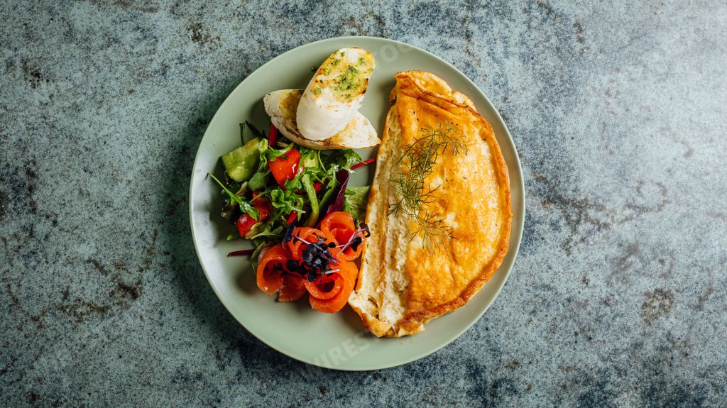 A top view of the plate with omelet and vegetables for healthy breakfast