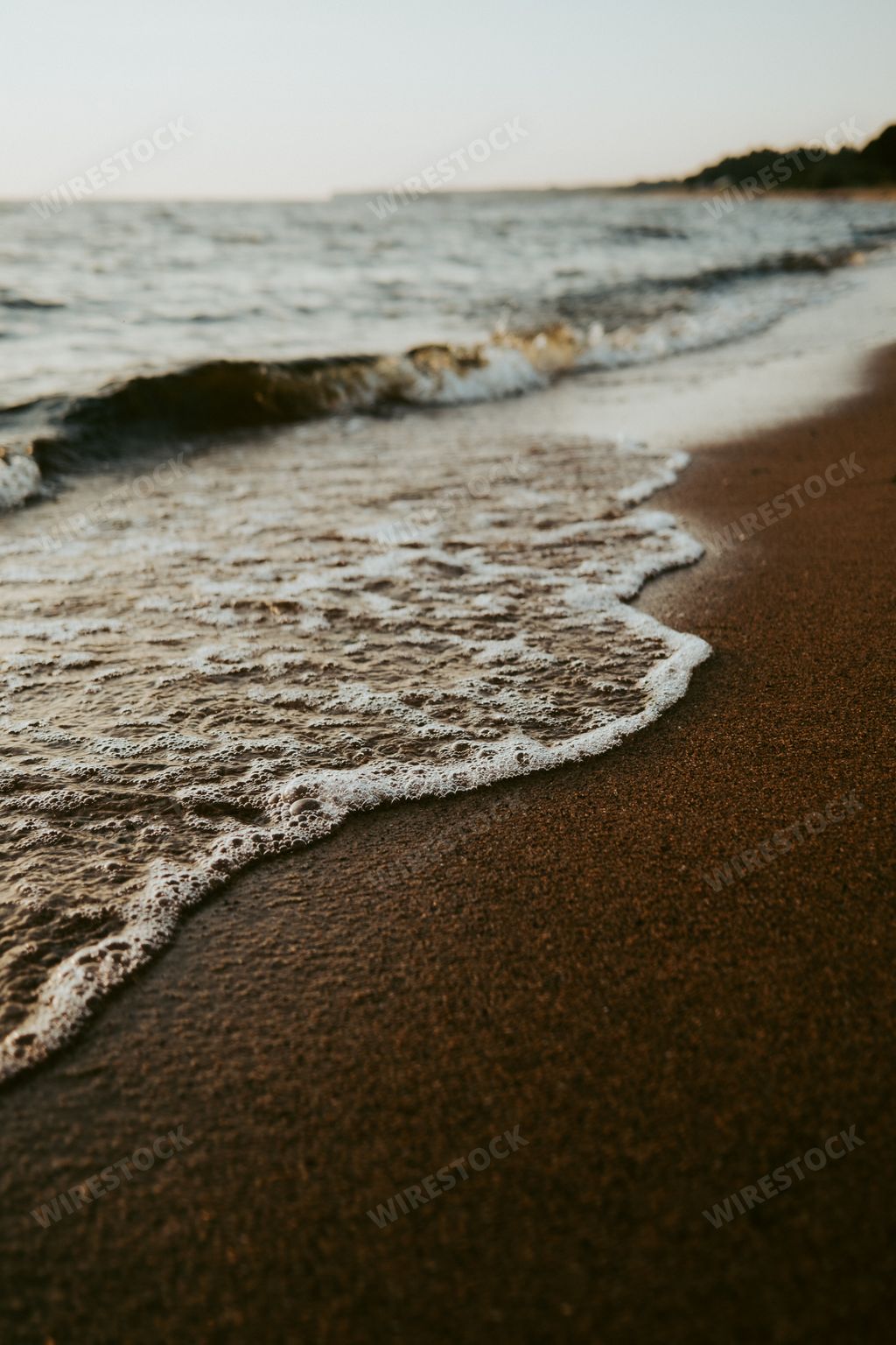 A beautiful scenery of the beach with splashing sea waves