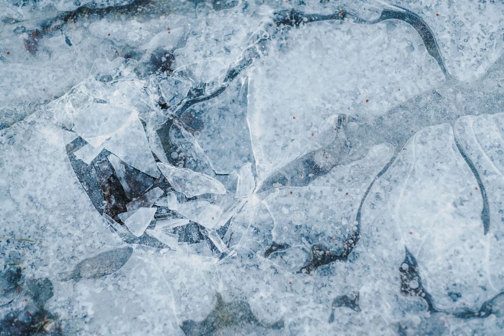 A closeup shot of Frozen puddle, broken ice texture
